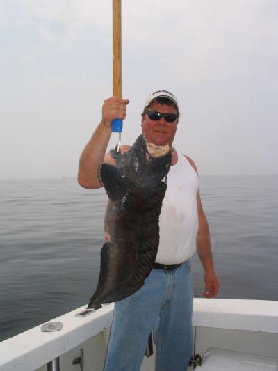 Stew Duncan with a large wolffish he landed on RELENTLESS while fishing on Stellwagen Bank On June, 2nd, 2007